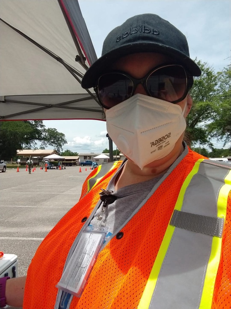 Lauren in a safety vest and N95 mask on duty during the COVID-19 response